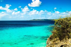 Daaibooi Beach Curaçao, a hidden gem with calm turquoise waters, white sandy shores, and excellent snorkeling opportunities surrounded by lush nature.