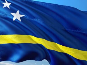 Curaçao Carnival parade with dancers in vibrant costumes, live music, and a festive crowd celebrating in the streets.