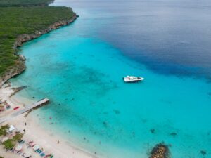 Traveler relaxing on a Caribbean beach in Curaçao – things you need to know before your trip.