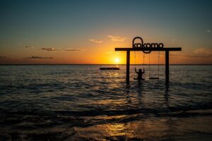 Colorful cocktails at a beach bar in Curaçao promoting the best happy hour spots on the island.