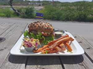 A juicy burger guide showing the top 10 places to eat the best burgers in Curaçao.