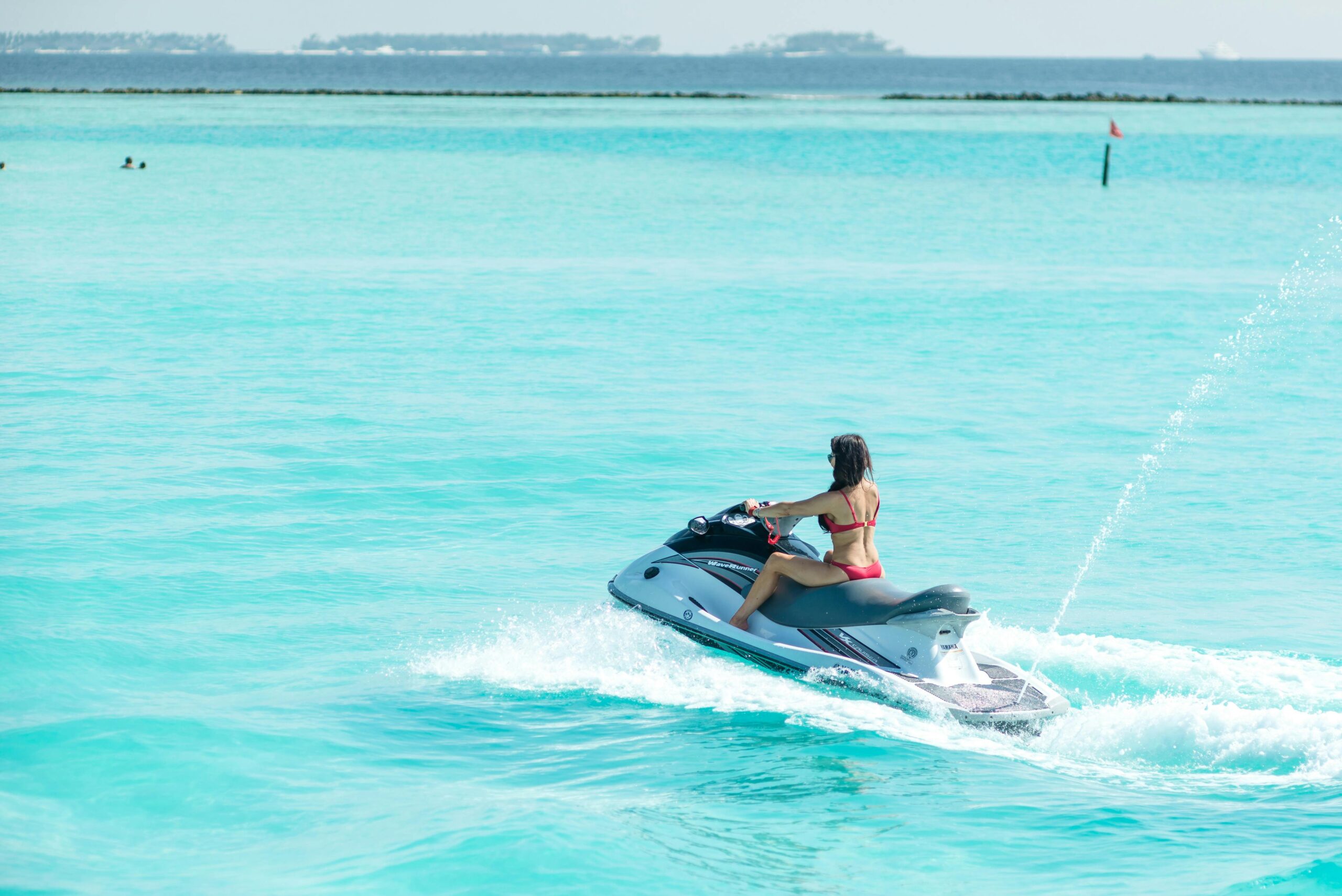 A thrilling jet ski tour in Curaçao, gliding over crystal-clear waters with stunning coastal views.