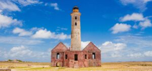 Klein Curacao, a pristine uninhabited island with crystal-clear waters, white sandy beaches, and a historic lighthouse.