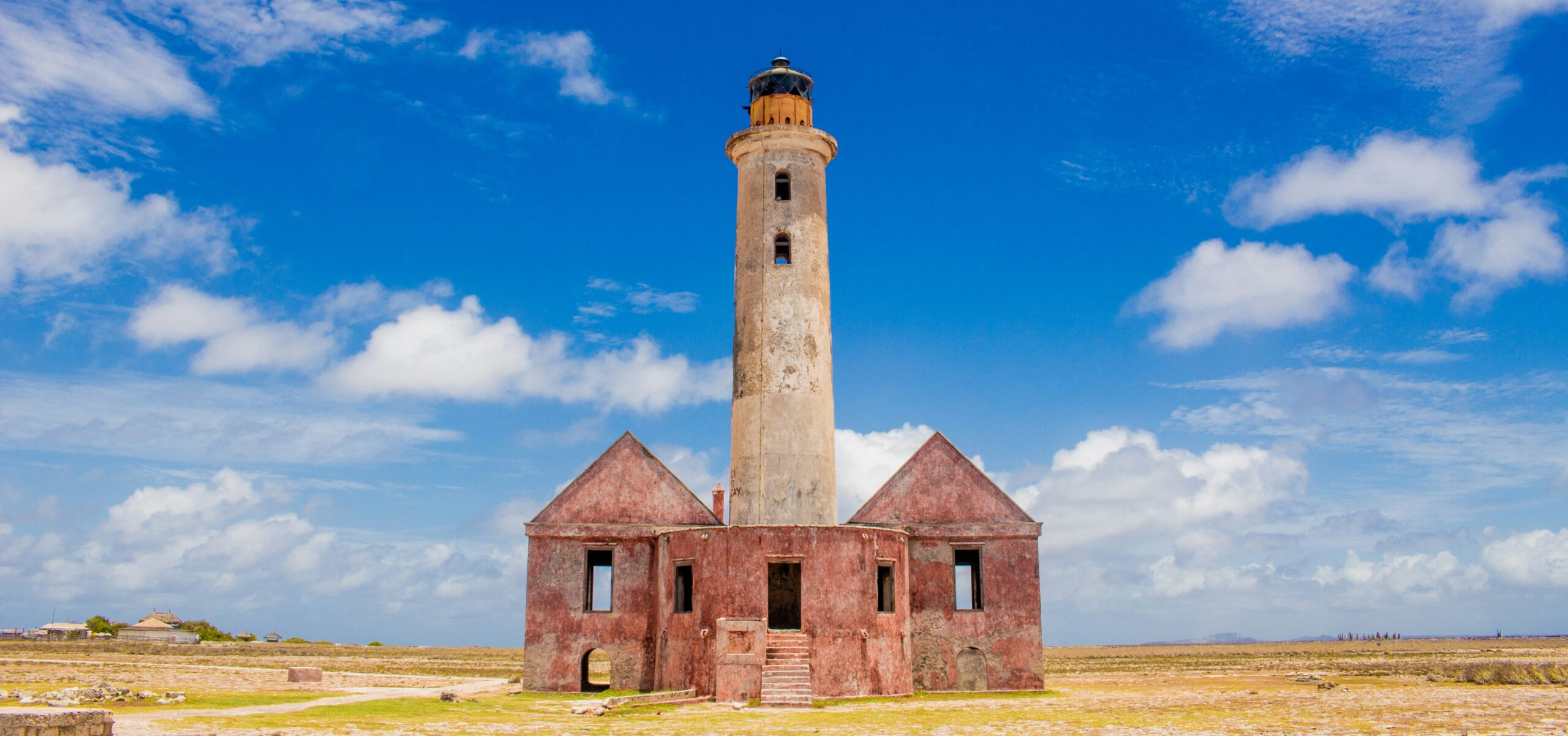 Klein Curacao, a pristine uninhabited island with crystal-clear waters, white sandy beaches, and a historic lighthouse.