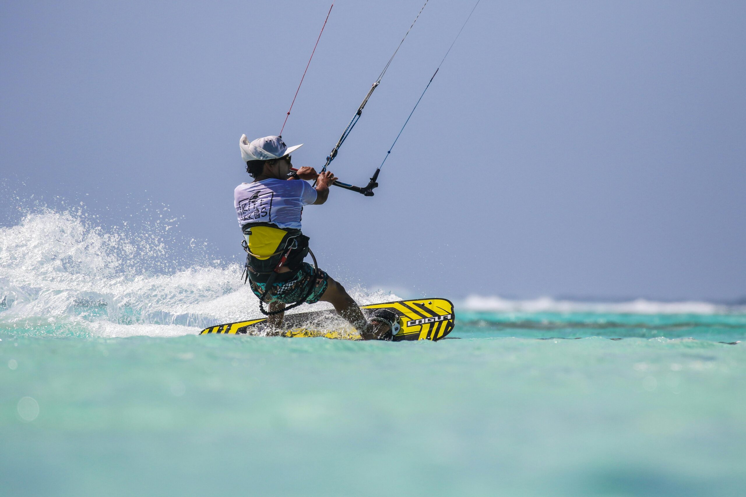 A wakeboarder gliding over the turquoise waters of Curaçao, enjoying an adrenaline-filled watersport activity.