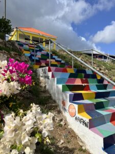 Colorful historic buildings along the waterfront in Willemstad, Curaçao, showcasing Dutch Caribbean architecture and lively city vibes.