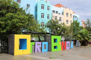 Curaçao bucket list with colorful Willemstad houses, white sandy beaches, and adventurous island activities.