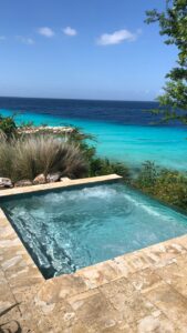 Curaçao bucket list with colorful Willemstad houses, white sandy beaches, and adventurous island activities.