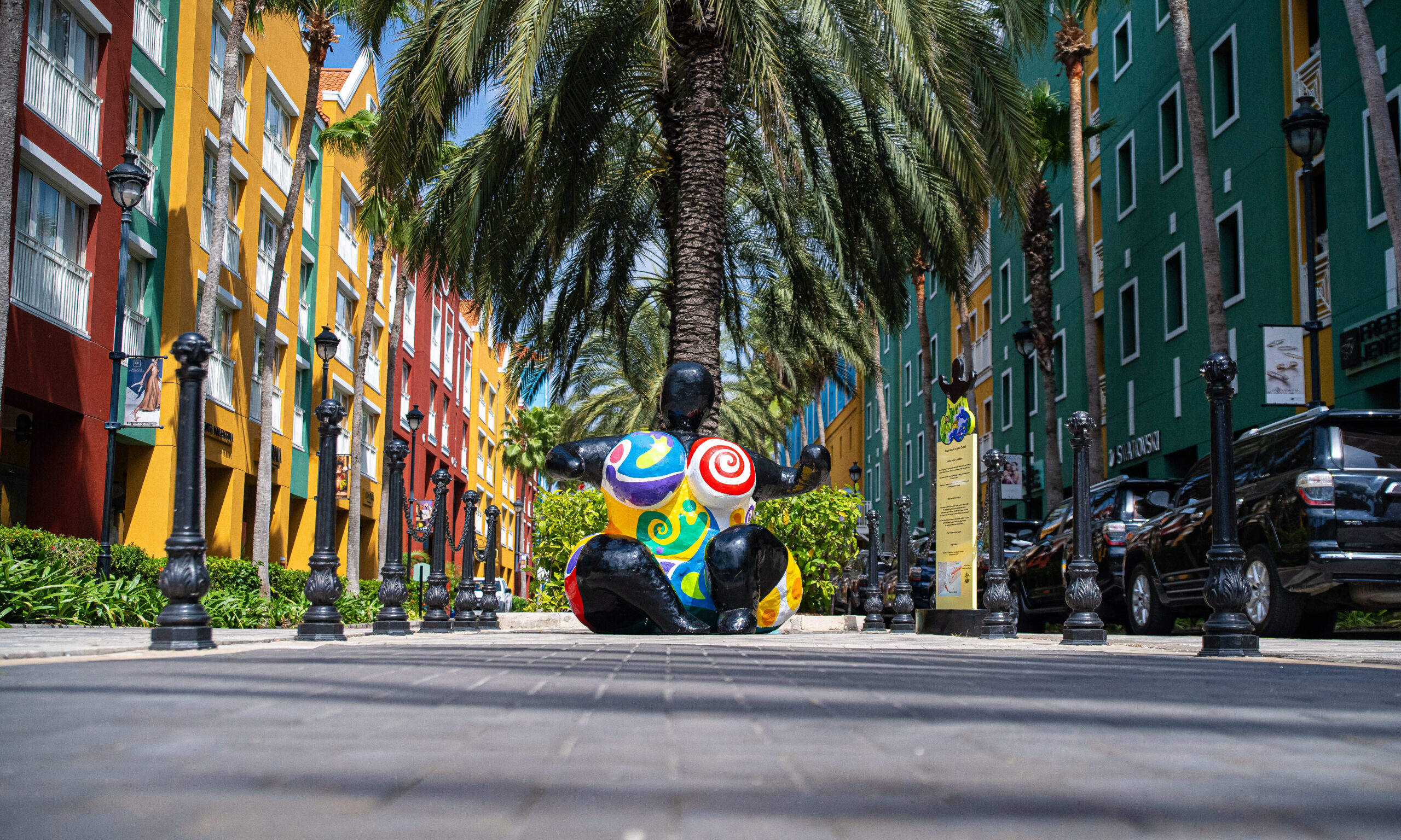 Tropical shopping street in Curaçao with colorful buildings and bright sunshine