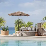 Adults enjoying cabanas and pool at Lemon Beach Club Curaçao