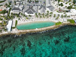 Aerial view of Papagayo Beach Resort in Jan Thiel, Curaçao with tropical beaches, pool, and palm trees