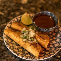 Stylish new restaurant in Curaçao with modern decor, tropical vibes, and guests enjoying Caribbean fusion dishes.