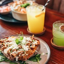 Stylish new restaurant in Curaçao with modern decor, tropical vibes, and guests enjoying Caribbean fusion dishes