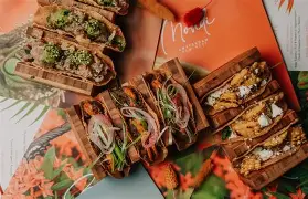 Stylish new restaurant in Curaçao with modern decor, tropical vibes, and guests enjoying Caribbean fusion dishes.