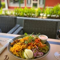 Children playing at a kid-friendly restaurant in Curaçao with outdoor seating, tropical garden, and family-friendly atmosphere.