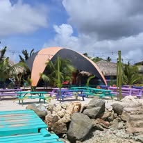 Children playing at a kid-friendly restaurant in Curaçao with outdoor seating, tropical garden, and family-friendly atmosphere.
