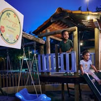 Children playing at a kid-friendly restaurant in Curaçao with outdoor seating, tropical garden, and family-friendly atmosphere.